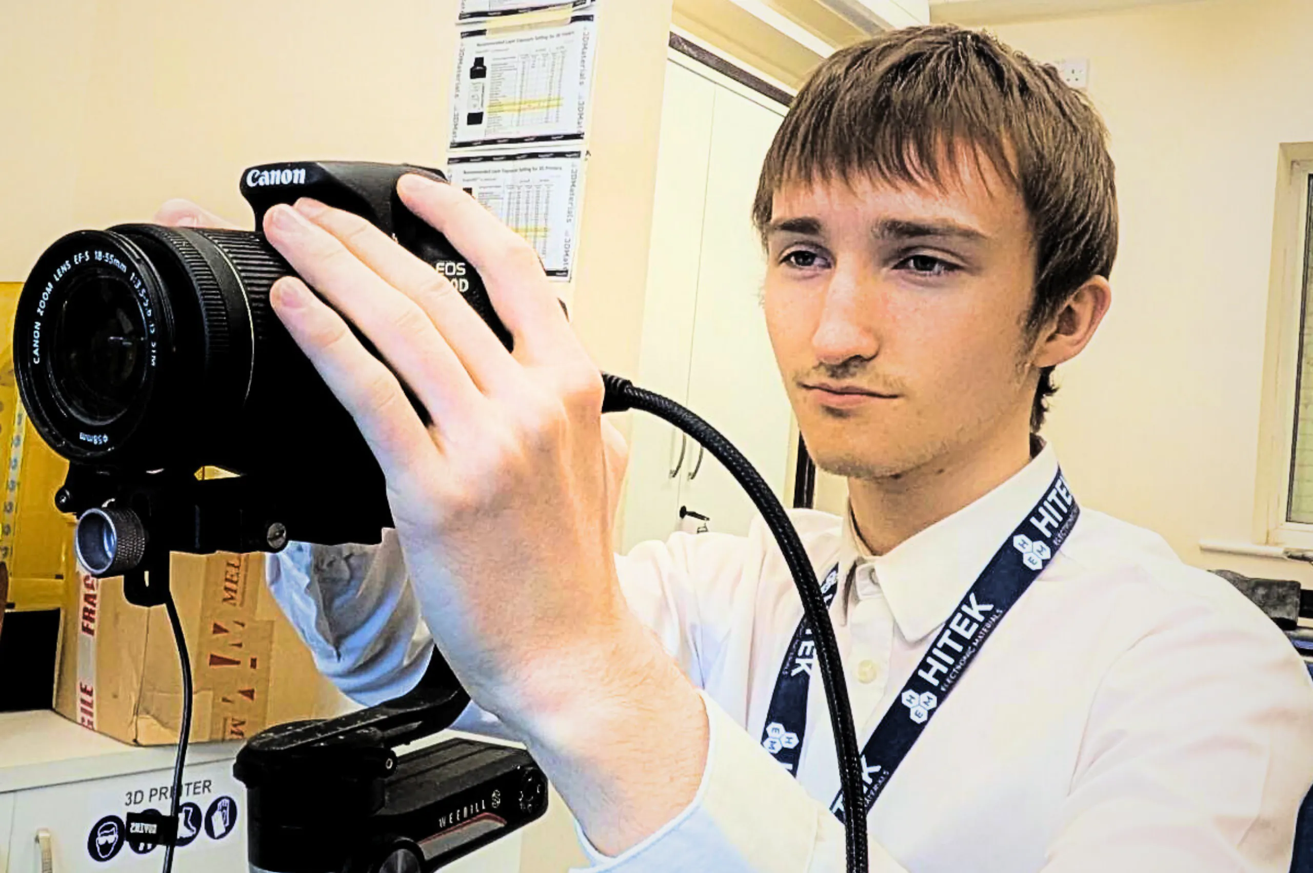 Lennon holding a camera, ready to take a photo.